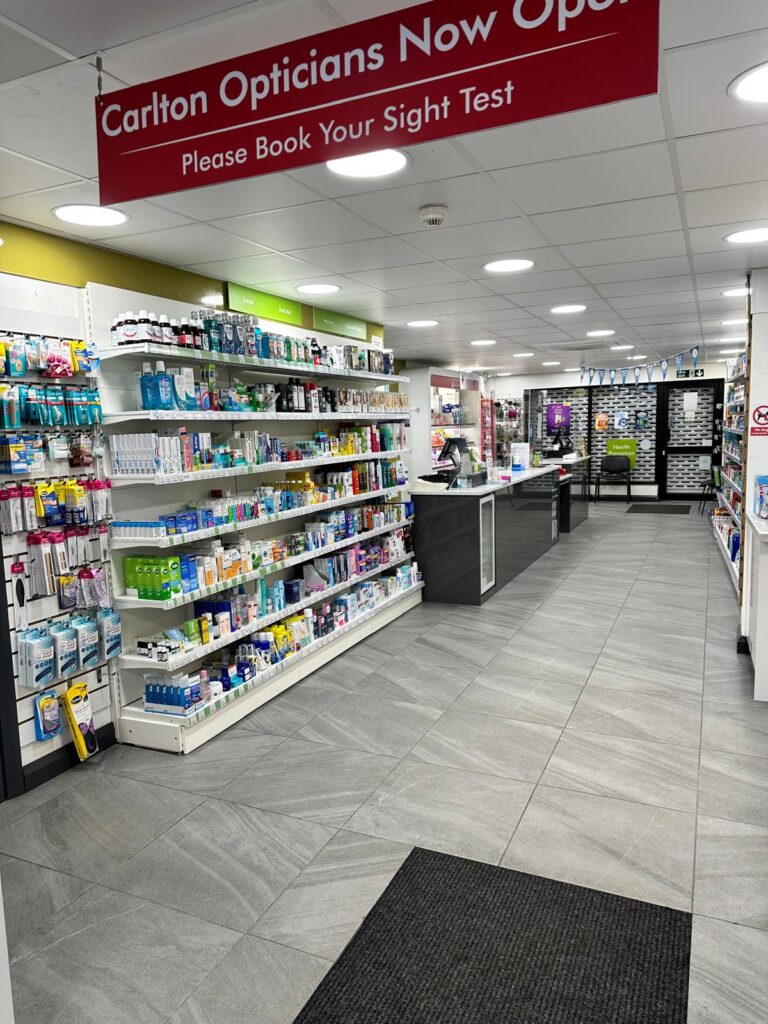Carlton Pharmacy interior with product shelves and opticians sign
